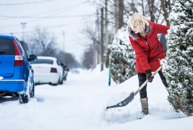 person shoveling snow from sidewalk