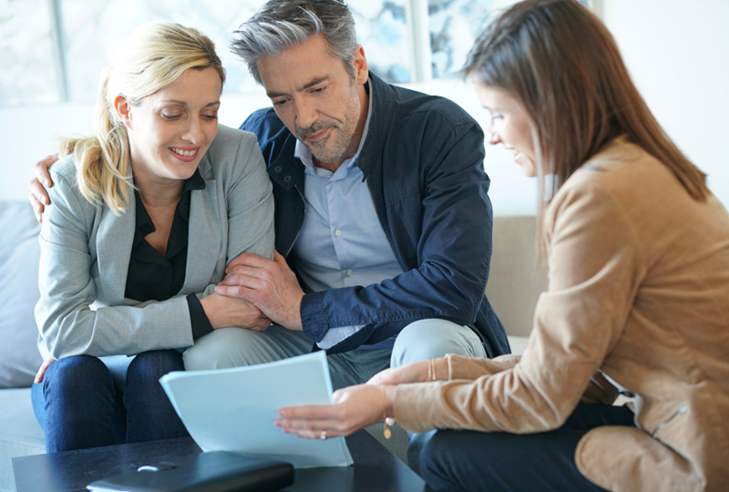 An agent walking sellers through the steps of selling their home