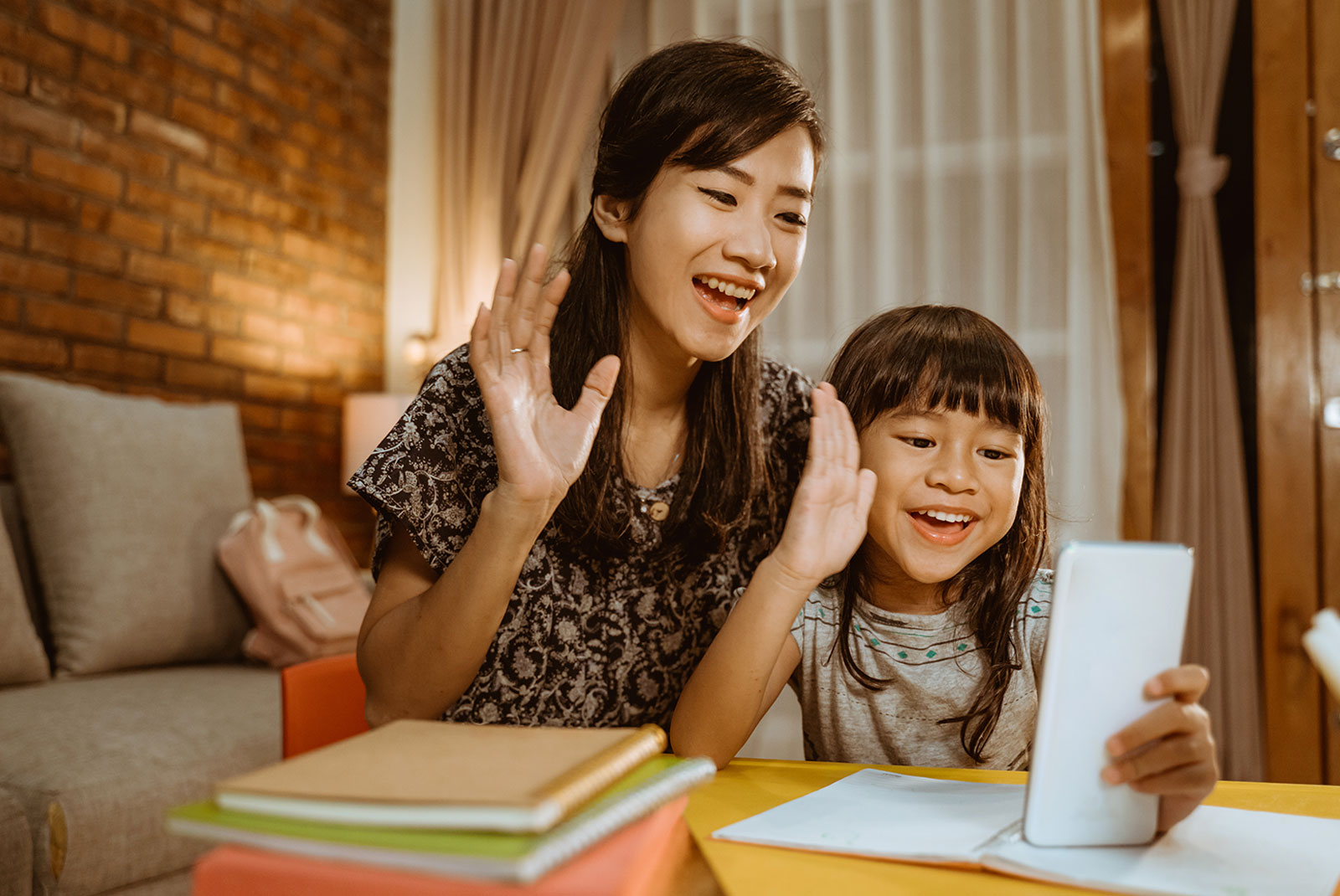 Family waving goodbye at a virtual housewarming party