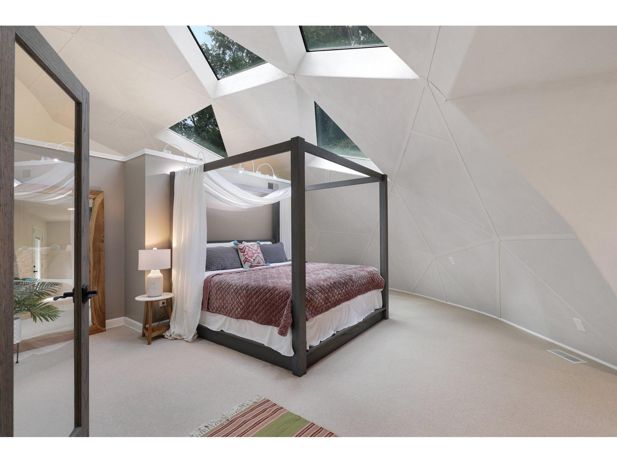 Master bedroom with triangle shaped windows